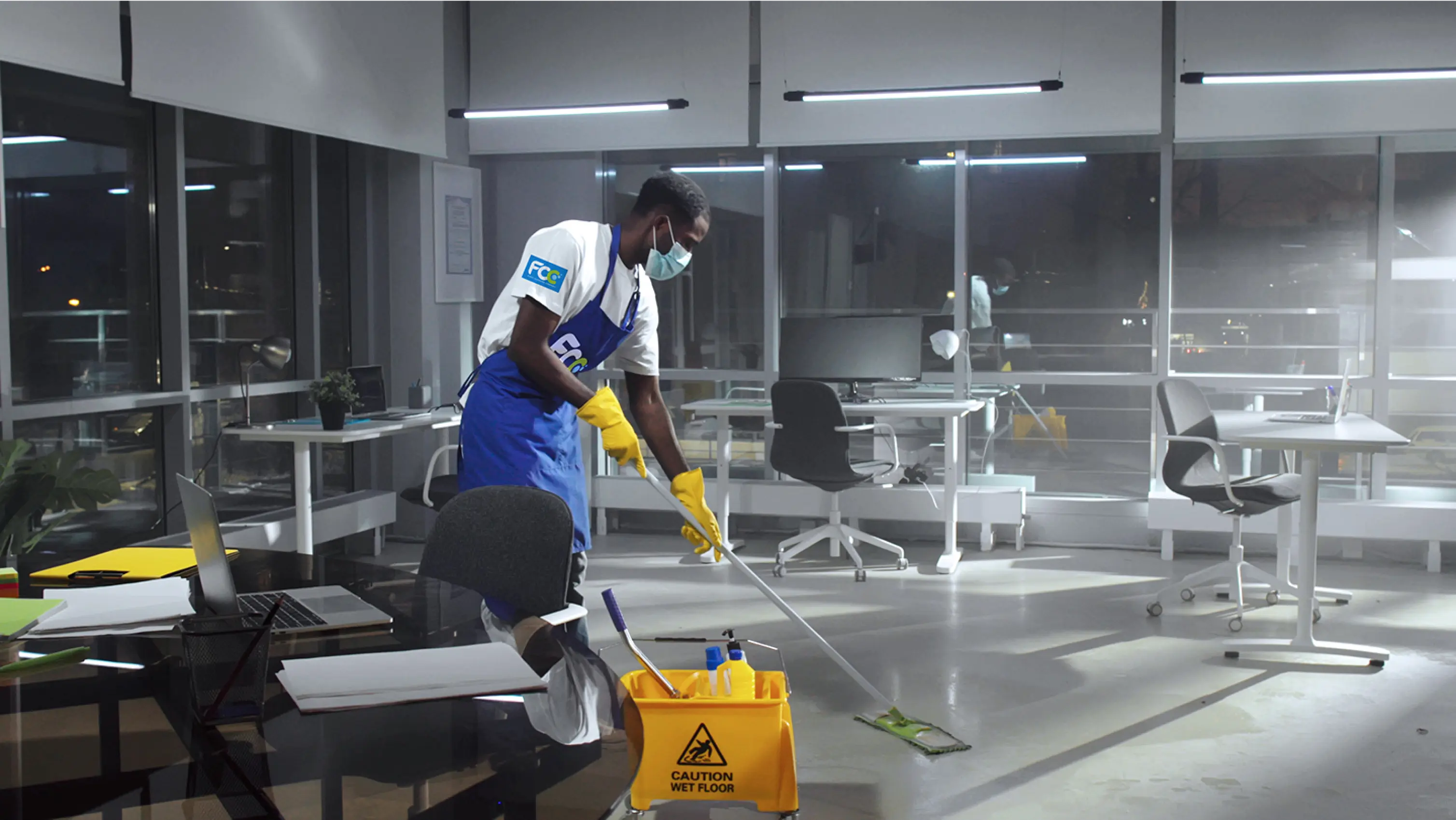 Cleaning professionals wearing masks and gloves